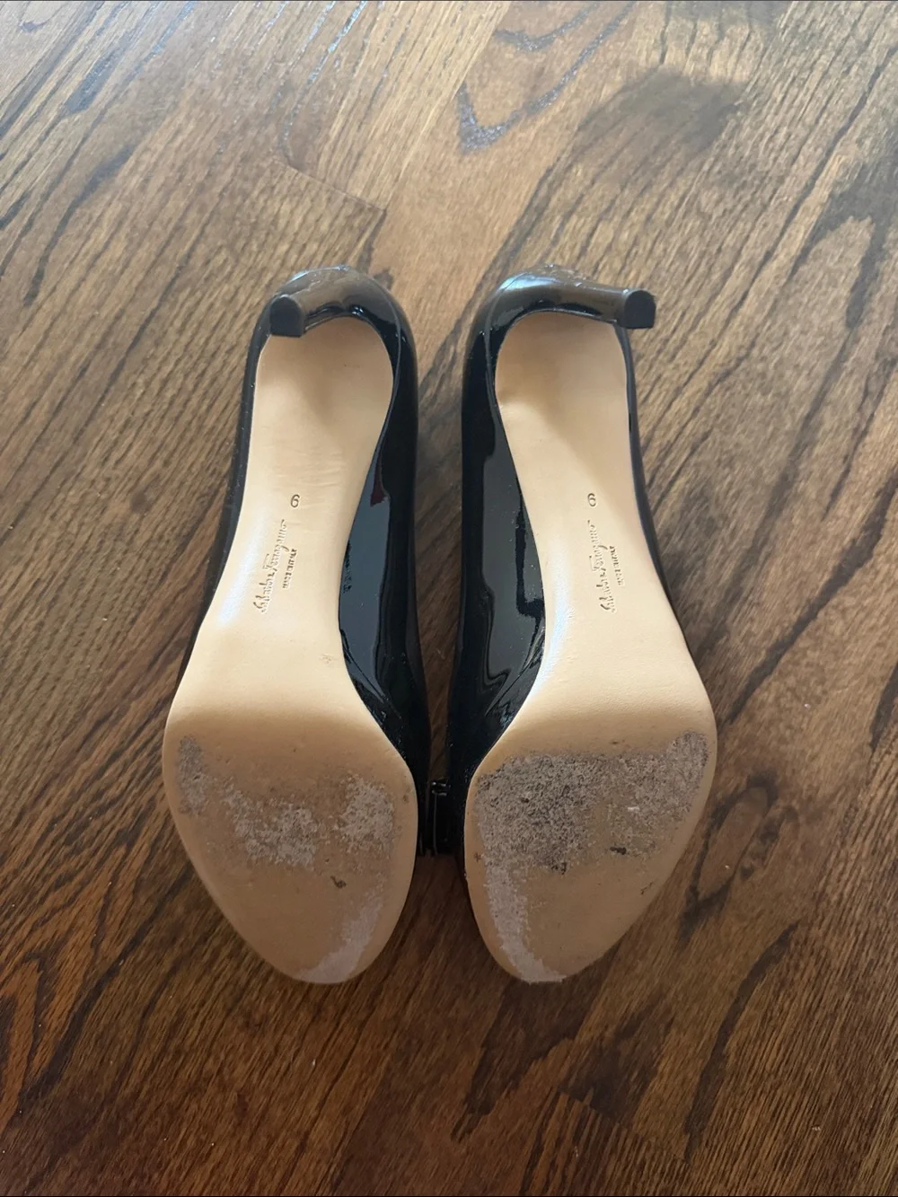 Salvatore Ferragamo Black Patent Vara Bow Pumps with Gold Plaque Accent